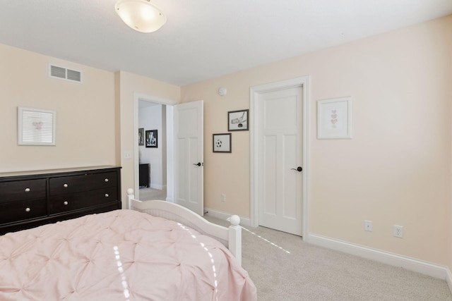 carpeted bedroom featuring visible vents and baseboards