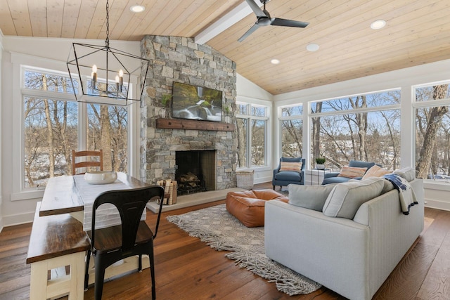 living area with wood ceiling, wood-type flooring, a fireplace, high vaulted ceiling, and ceiling fan with notable chandelier