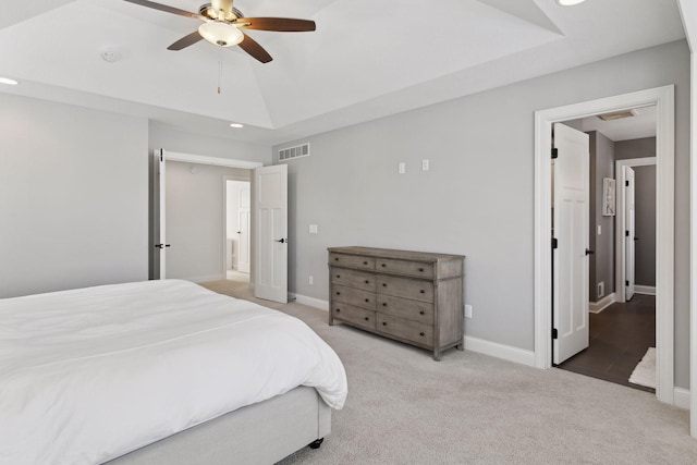 carpeted bedroom with lofted ceiling, baseboards, visible vents, and ceiling fan