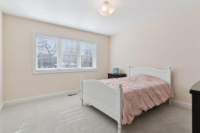 bedroom featuring carpet and baseboards