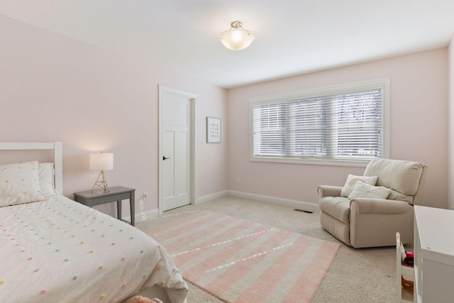 bedroom with light carpet, visible vents, and baseboards