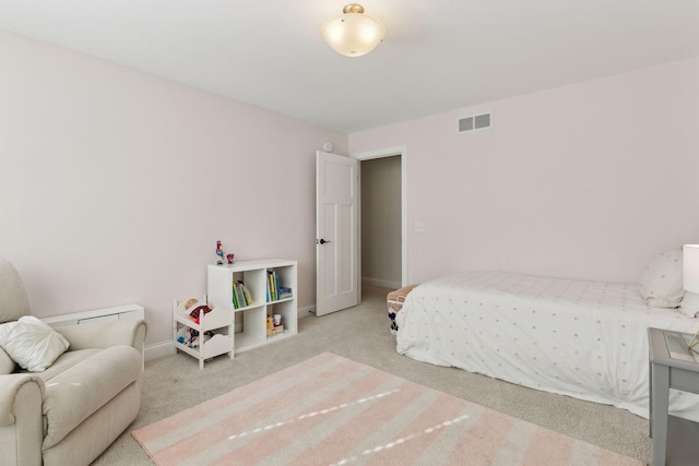 carpeted bedroom featuring baseboards and visible vents
