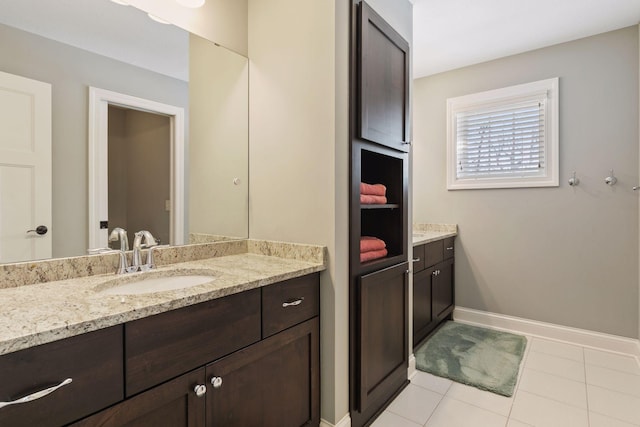 bathroom with tile patterned flooring, vanity, and baseboards