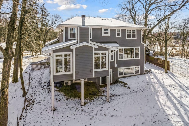 snow covered property with fence