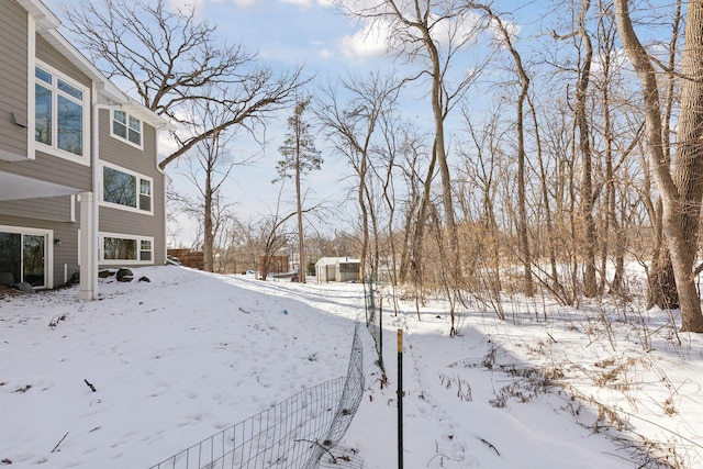 yard covered in snow with a garage