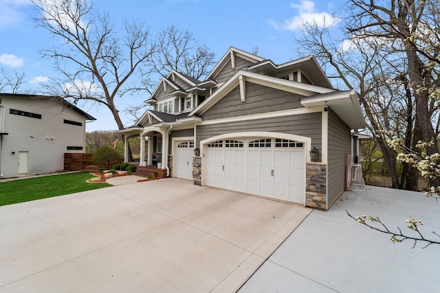 297 Glenbrook Rd N, Wayzata, MN 55391 - view of front of home with stone siding, concrete driveway, a garage, and a porch