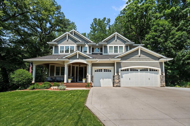 297 Glenbrook Rd N, Wayzata, MN 55391 - craftsman inspired home featuring covered porch, driveway, a front lawn, an attached garage, and stone siding