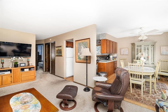 carpeted living room featuring ceiling fan