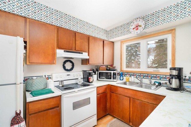 kitchen featuring sink and white appliances