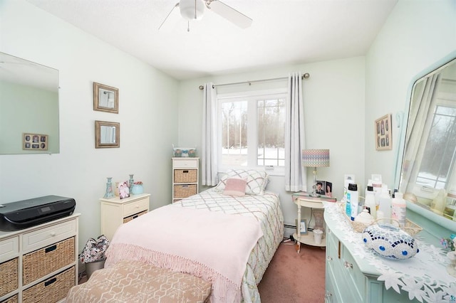 bedroom with ceiling fan, a baseboard heating unit, and dark colored carpet