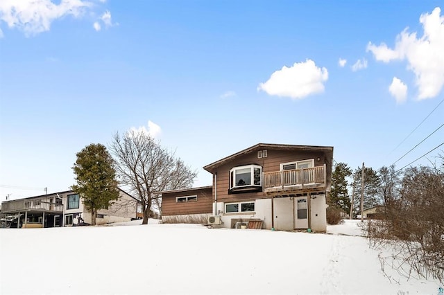 view of snow covered back of property