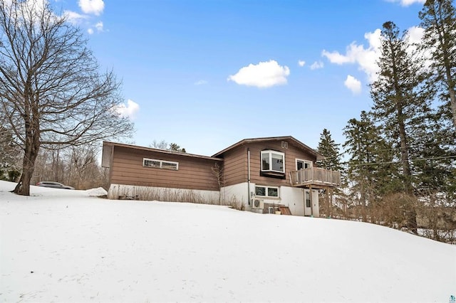 view of snow covered rear of property