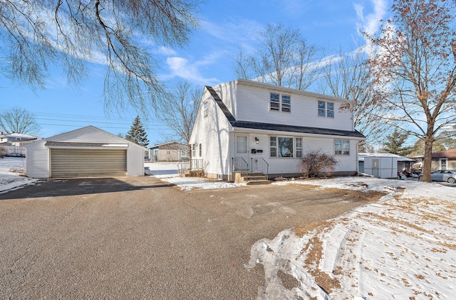 view of front of home with a garage and an outdoor structure