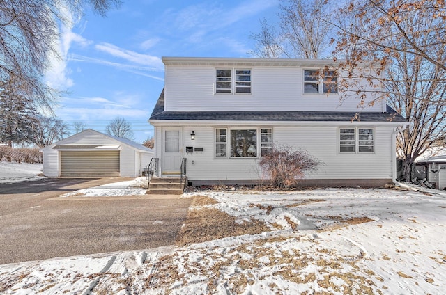 front of property with an outdoor structure and a garage