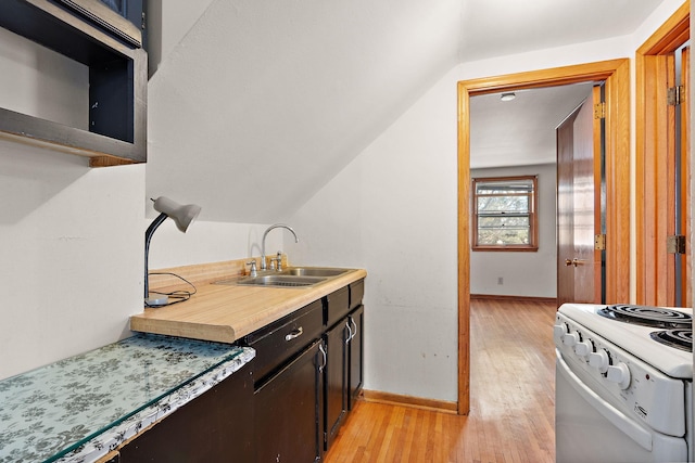 kitchen featuring sink, light wood-type flooring, dark brown cabinets, vaulted ceiling, and electric stove