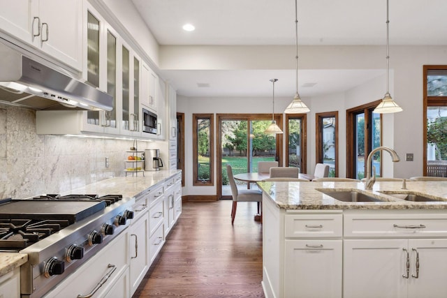 kitchen featuring white cabinets, stainless steel appliances, backsplash, and sink