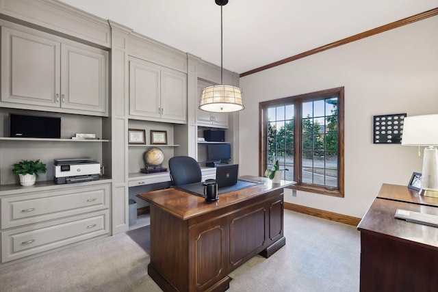 carpeted home office with built in shelves and ornamental molding