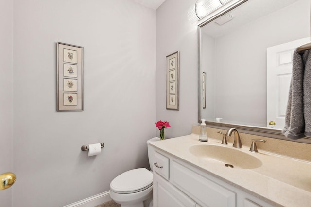 bathroom with toilet and vanity