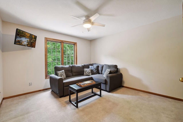 carpeted living room with ceiling fan