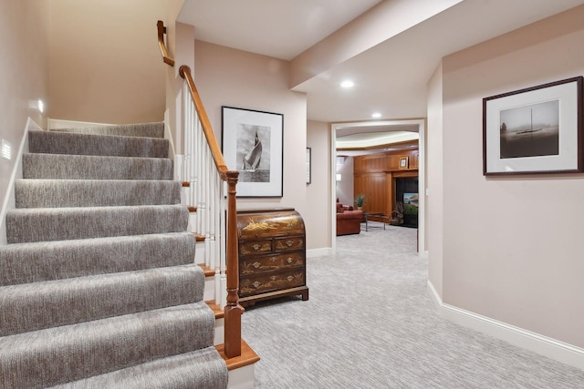 staircase featuring carpet