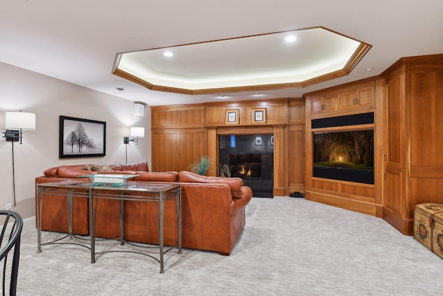 living room featuring light colored carpet and a raised ceiling