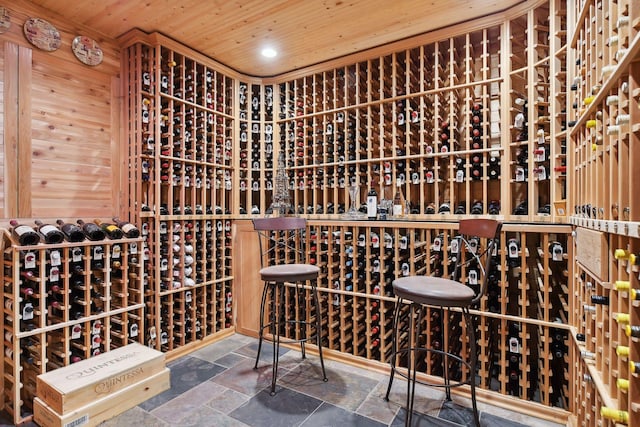 wine area with wooden ceiling and wood walls