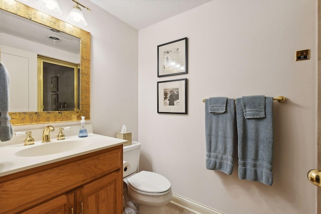 bathroom featuring toilet and vanity