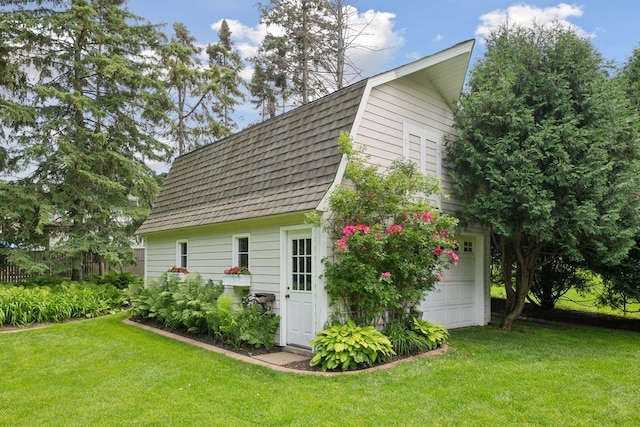 view of outbuilding with a lawn