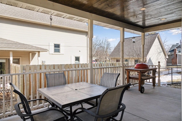 view of patio featuring outdoor dining area and fence