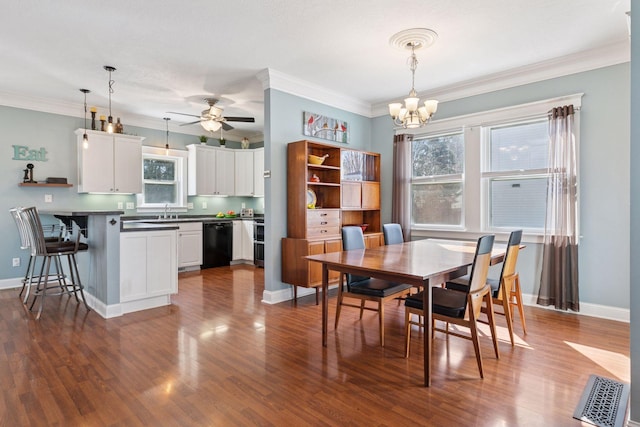 dining space featuring baseboards, dark wood-style floors, ornamental molding, and ceiling fan with notable chandelier