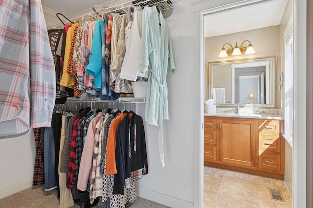 spacious closet featuring a sink and visible vents