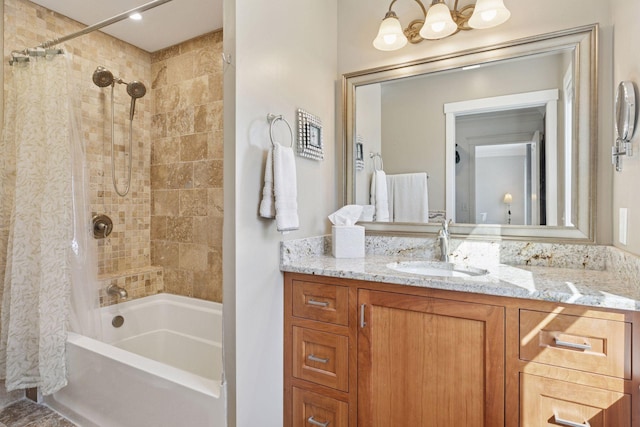 bathroom featuring shower / bath combo and vanity