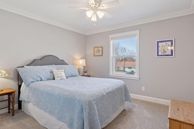 bedroom featuring ceiling fan, ornamental molding, baseboards, and light carpet