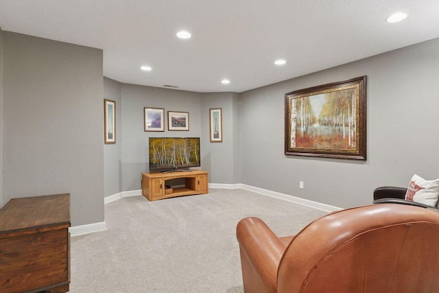 living area with recessed lighting, baseboards, and light carpet