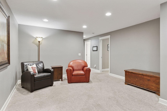 living area featuring light carpet, recessed lighting, and baseboards