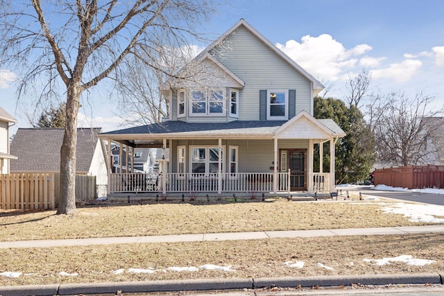 view of front of home featuring a porch and fence