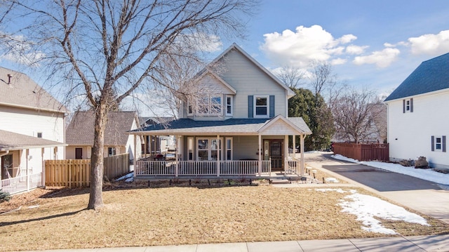 view of front of house featuring a porch and fence