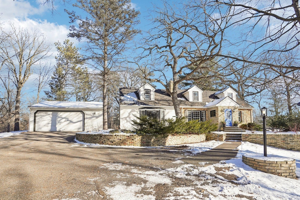 new england style home with a garage