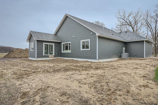 back of property with a shingled roof