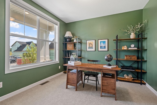 carpeted office featuring baseboards and visible vents