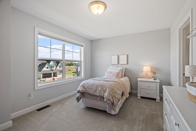 bedroom featuring dark carpet, visible vents, and baseboards