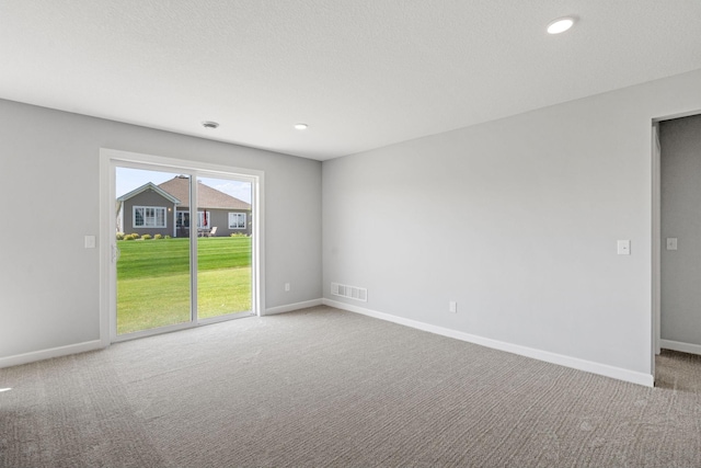 carpeted empty room featuring recessed lighting, visible vents, and baseboards