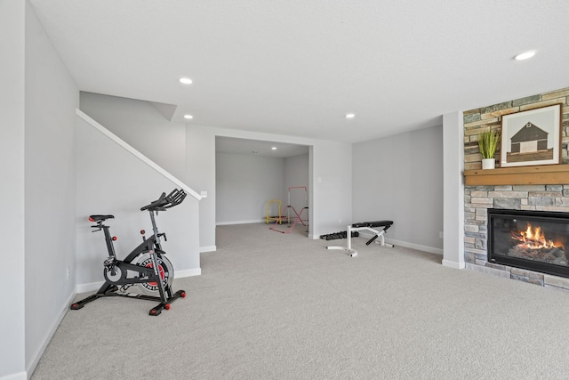 exercise room featuring carpet floors, recessed lighting, a fireplace, and baseboards