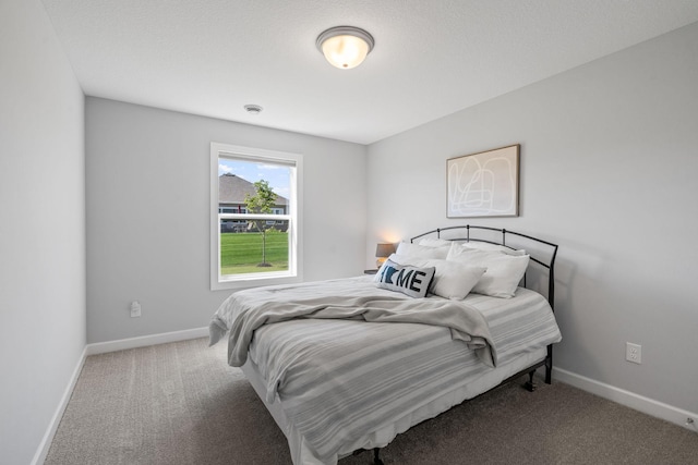 carpeted bedroom featuring baseboards