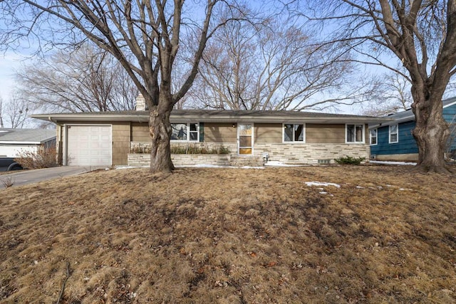 ranch-style home with a garage, stone siding, and driveway