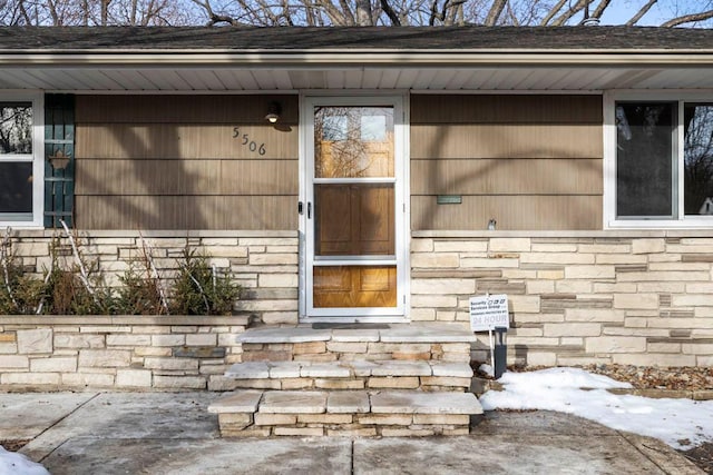 property entrance with stone siding