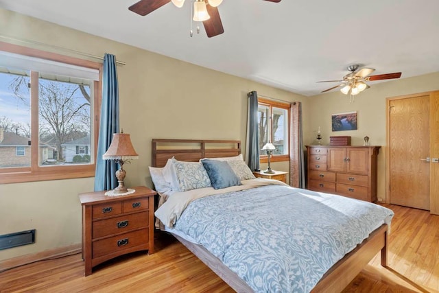 bedroom with ceiling fan and light wood-style flooring