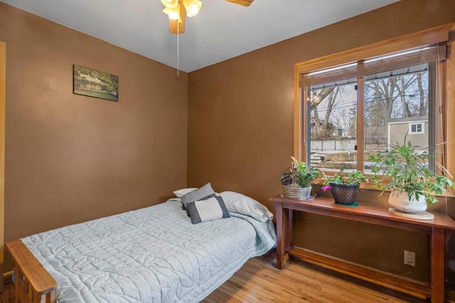 bedroom featuring wood finished floors and a ceiling fan