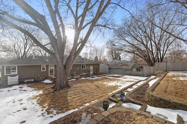 snowy yard with entry steps and fence