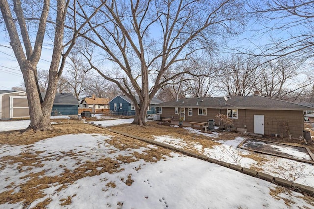 view of front facade featuring a residential view, a detached garage, and a chimney